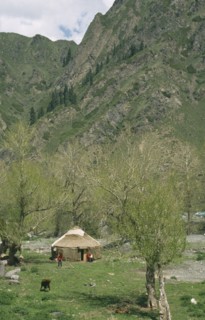 CHINA, Xinjiang, Tanchi, Kazak Yurt. Tent house with family outside