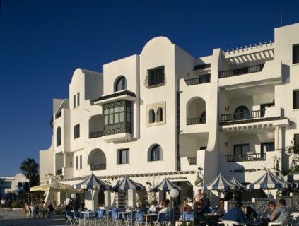 TUNISIA, Port El Kantaoui , Villas in an Arab style. Tourists sitting at tables outside cafe on