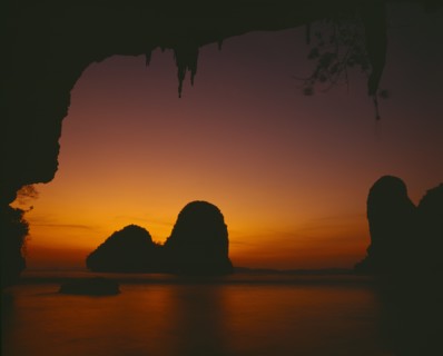 THAILAND, South, Krabi, "Phra Nang beach, orange sunset behind rock formations in the sea "