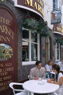 ENGLAND, East Sussex, Brighton, Couple outsdie the Cricketers Pub.