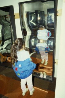 ENTERTAINMENT, Fairground, Crazy Mirrors, Young girl looking at her own distorted reflection in