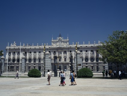 SPAIN, Madrid State, Madrid, Royal Palace. Tourists in square outside railings with gates