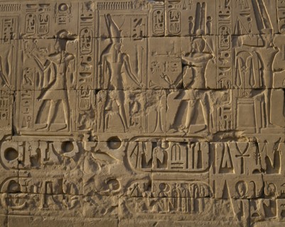 EGYPT, Nile Valley, Karnak, "Karnak Temple.  Hieroglyphic details carved in stone wall, people and