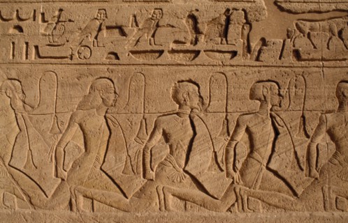 EGYPT, Abu Simbel, Hieroglyphics above relief carving of Nubian slaves