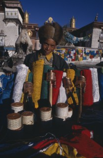 CHINA, Tibet, Lhasa, Prayer flag vendor at Jokhang Temple