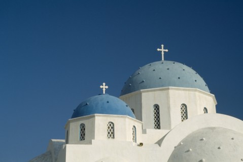 GREECE, Cyclades Islands, Santorini, Perissa.  Blue domed rooftops of white painted church.