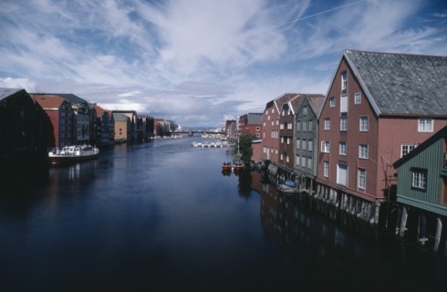 NORWAY, Sor Trondelag, Trondheim , Wharf area. Traditional wooden waterfront buildings with bridge