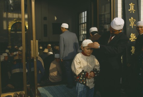 CHINA, Gansu Province, Lanzhou, Family outside mosque.