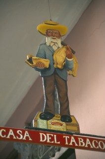 CUBA, Havana Province, Havana, Sign hanging outside cigar shop showing bearded old man in hat