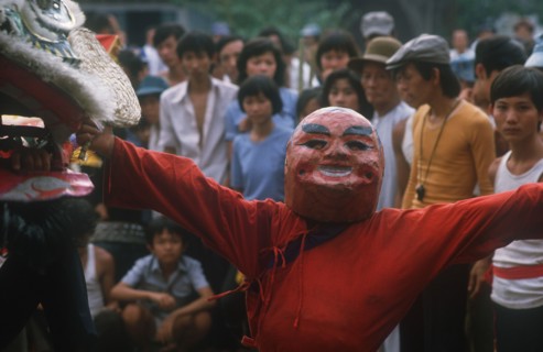 VIETNAM, Ho Chi Minh City , Ton San Village.  Dancer wearing carnival head at Tet dance celebrating