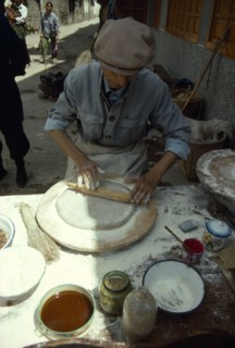 CHINA, Yunnan Province, Dali, Man making moon cakes.