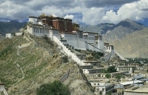 TIBET, Lhasa, Potala Palace, Near view of buildings set on hill in valley surrounded by mountains