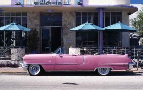 USA, Florida, Miami, Ocean Drive. Pink Cadillac parked outside Art Deco style Marlin Hotel on South