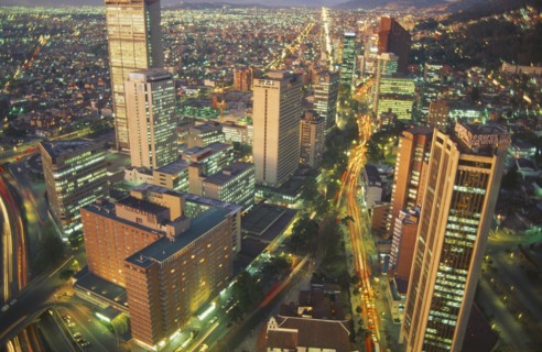 COLOMBIA, Bogota, Aerial view of city highrises illuminated at night