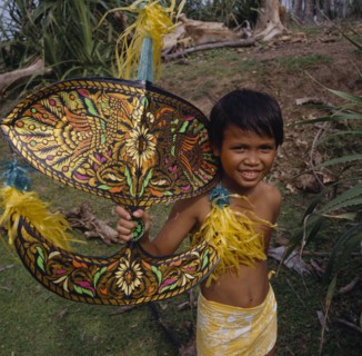 MALAYSIA, Kelantan, Kota Baharu, Malay boy holding multicoloured kite