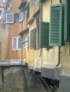 ITALY, Tuscany, Florence, Shutters on houses on  the Ponte Vecchio over the River Arno