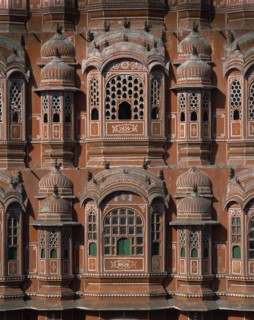 INDIA, Rajasthan, Jaipur, Palace of the Winds. Detail of orange and white carvings