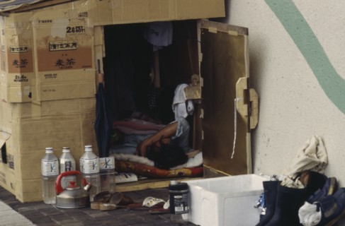 JAPAN, Honshu, Tokyo, Homeless man living in a cardboard box