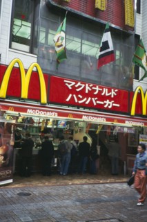 JAPAN, Honshu, Tokyo, McDonalds fast food restaurant with customers and sign above written in