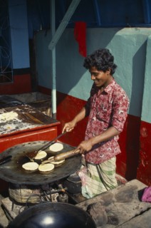 BANGLADESH, Khulna, Barisal, Cooking breads outside restaurant.