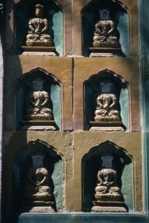 CHINA, Beijing, Summer Palace, Detail of  wall statues with the heads missing from all but one