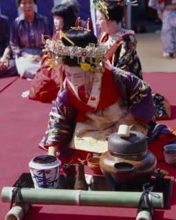 JAPAN, Honshu, Kyoto, Woman in Court costume preparing the Tea Cermony