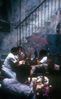CUBA, Havana, Bodequita del Medio Bar with people sitting at tables in an alley by a stairway and