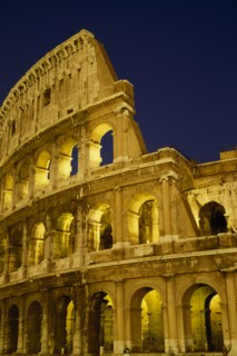 ITALY, LAZIO ,  ROME, The Colosseum exterior view at night of floodlit walls set against dark sky.