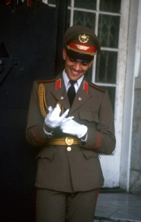 CUBA, Havana, Man in military uniform putting on white gloves