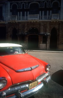 CUBA, Havana, Detail of red US style car parked on Old Havana street.