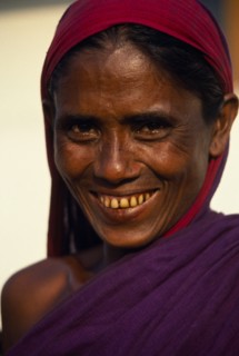 BANGLADESH, Khulna, Barisal, Head and shoulders portrait of smiling woman.
