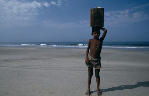 INDIA, Goa, Colva Beach, Young boy from Karnataka selling drinks on the beach