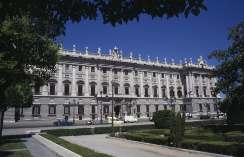 SPAIN, Madrid State, Madrid, The Royal Palace exterior framed by tree branches
