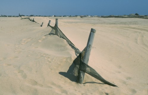 NAMIBIA, Swakopmund, Barrier to stop encroachment of sand dunes.