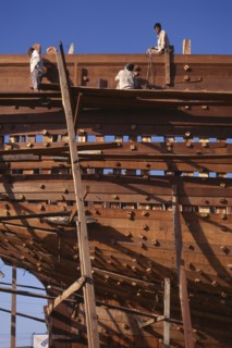 INDIA, Gujurat, Veraval, Shipbuilding.  Men at work on boat
