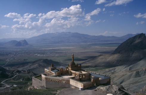 TURKEY, Dogubeyazit, Ishak Pasha Palace. View over hillside palace toward valley and mountains in