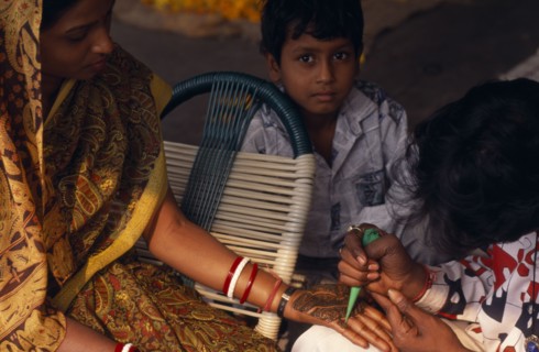 INDIA, Religion, Hindu, Woman having the palms of her hands decorated in Henna for her wedding with