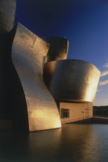 SPAIN, Basque Province, Bilbao, The Guggenheim Museum deatail with golden sunshine reflected at