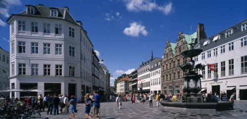 DENMARK, Zealand, Copenhagen , Stoget. People walking along street between traditional building
