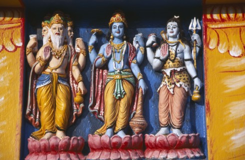 INDIA, Orissa, Gopalpur on Sea, Detail of brightly coloured temple statues of the Hindu Gods Vishnu