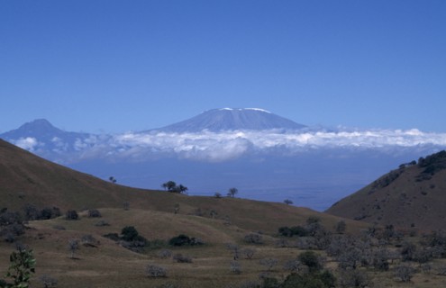TANZANIA, Mount Kilimanjaro, View over landscape toward Kilimanjaro Volcano with the summit visible