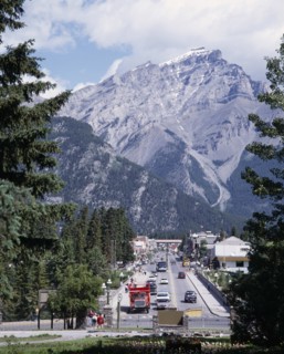 CANADA, Alberta, Banff, Banff Avenue the main straight street with a mountain peak behind seen