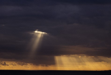 WEATHER, Climate, Clouds, Sun rays breaking through thick grey cloud.