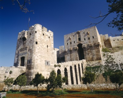 SYRIA, North, Aleppo, The Citadel.  Exterior of stone fortification and arched viaduct between