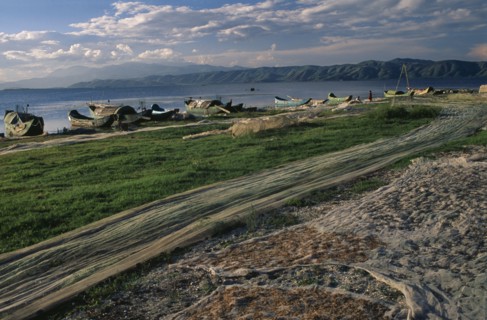 CHINA, Yunnan, Dali , Drying nets and fishing boats beside Er Hai Lake.
