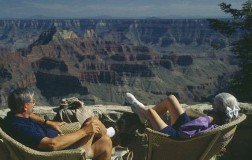 USA, Arizona, Grand Canyon, The North Rim with elderly couple seated