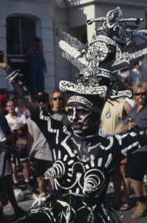 ENGLAND, London, Notting Hill Carnival dancer dressed in a black and white costume and face paint