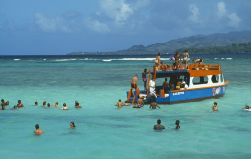 WEST INDIES, Tobago, Buccoo Reef, The Nylon Pool with tourists swimming or standing in shallow