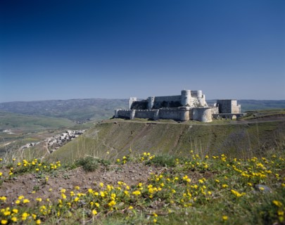 SYRIA, Central, Crac des Chevaliers, Crusader Castle in distance on plateau with village partly