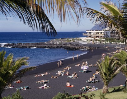 SPAIN, Canary Islands, Tenerife, Playa de la Arena near Los Gigantes with sunbathers on black sandy